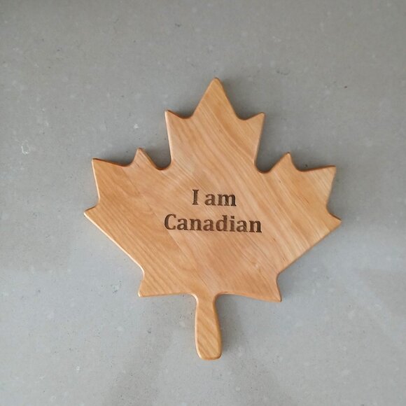 Charcuterie/Cutting Board in the shape of a maple leaf with "I am Canadian" - Picture 1 of 4